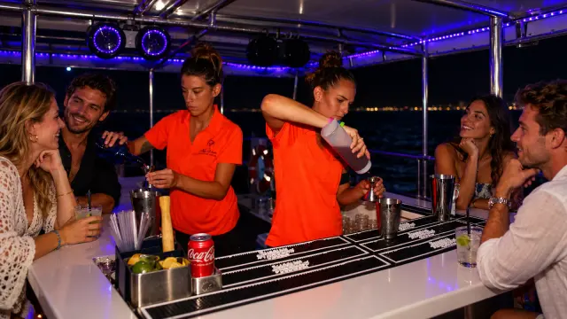 Bartenders mixing craft cocktails for guests at the onboard bar